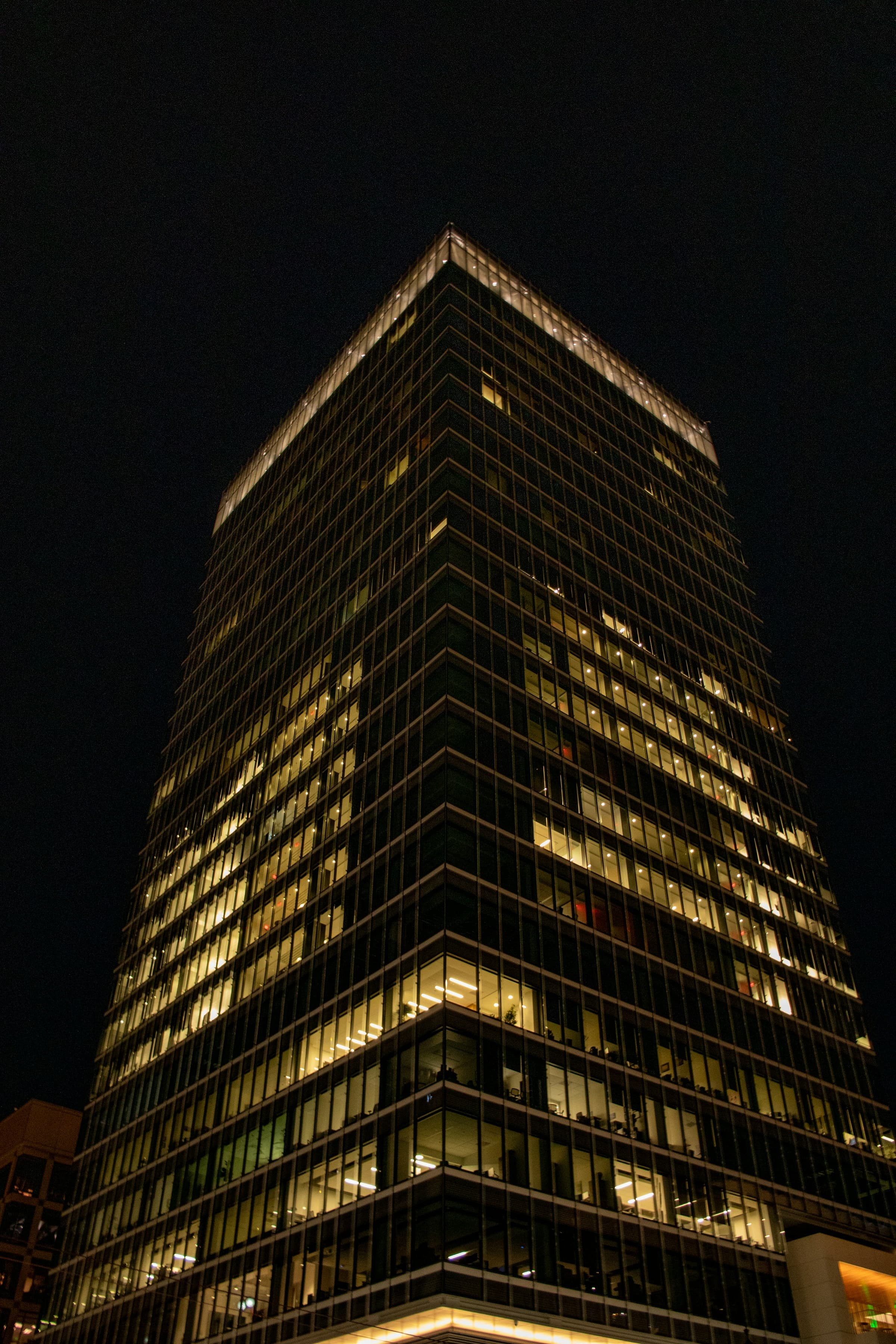 Gray concrete high-rise photographed at night
