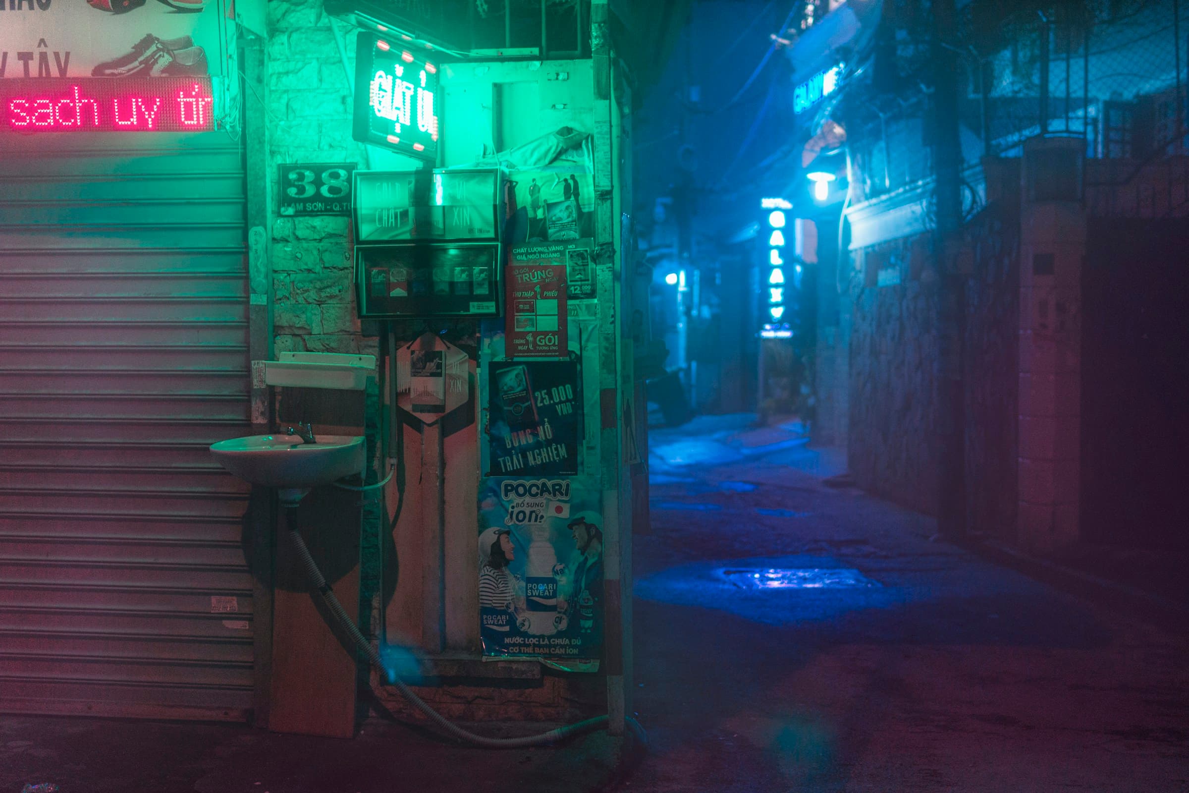Figure standing outside an illuminated shopfront at night