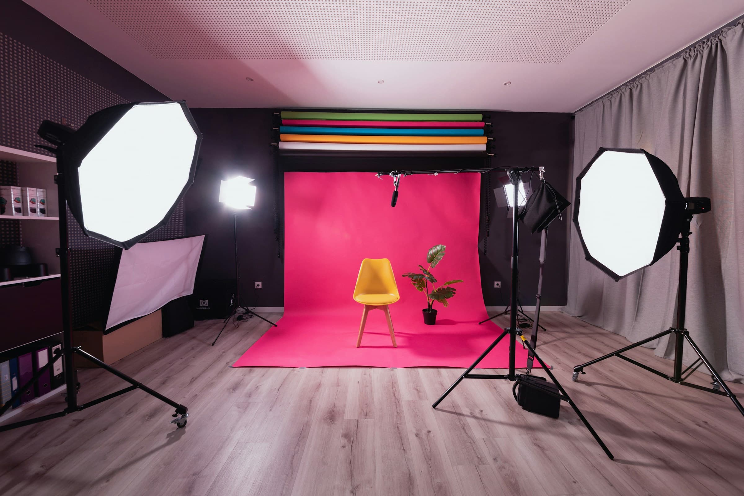 Photography studio with a seamless backdrop and a single chair