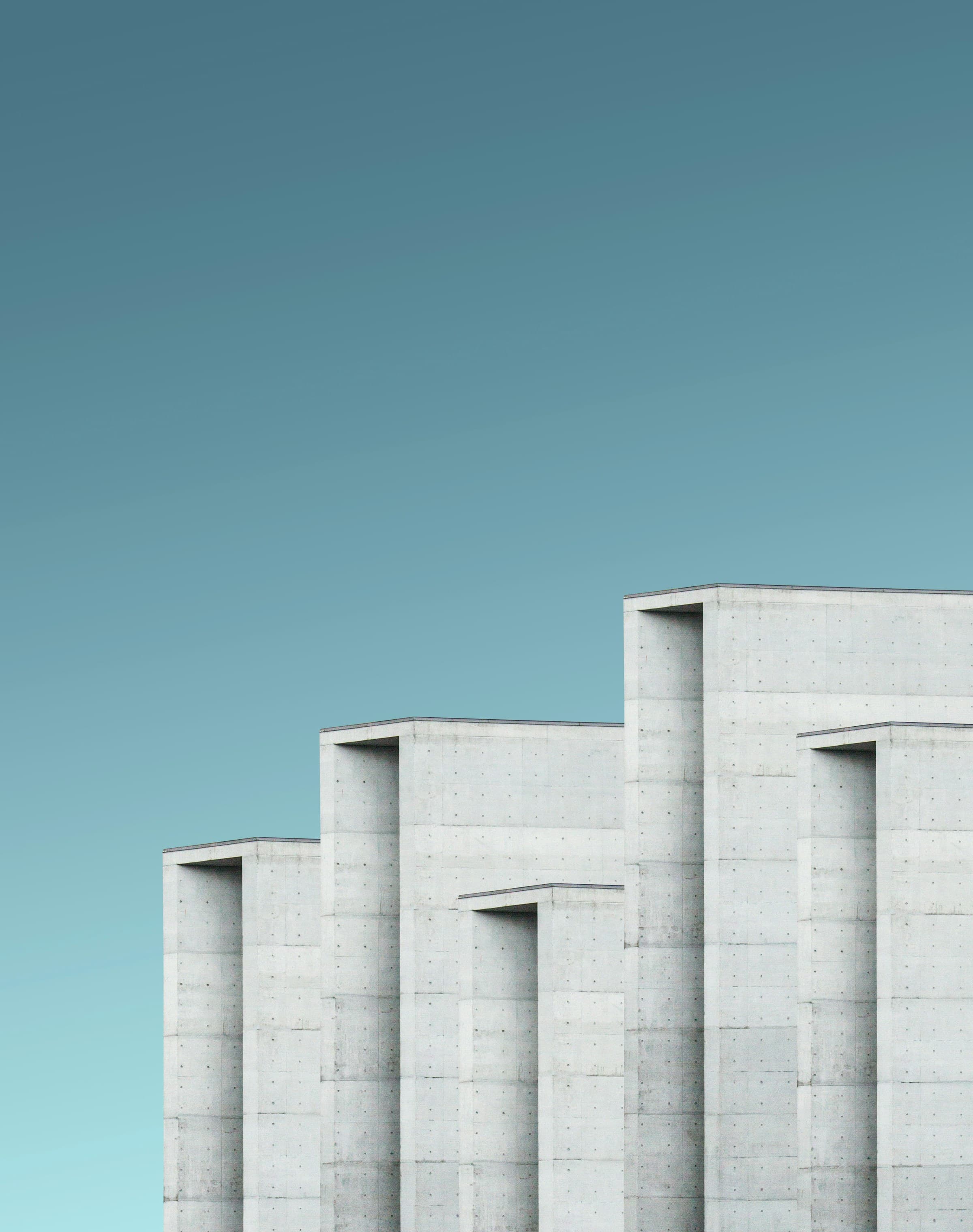 Monolithic concrete facade photographed against an open sky