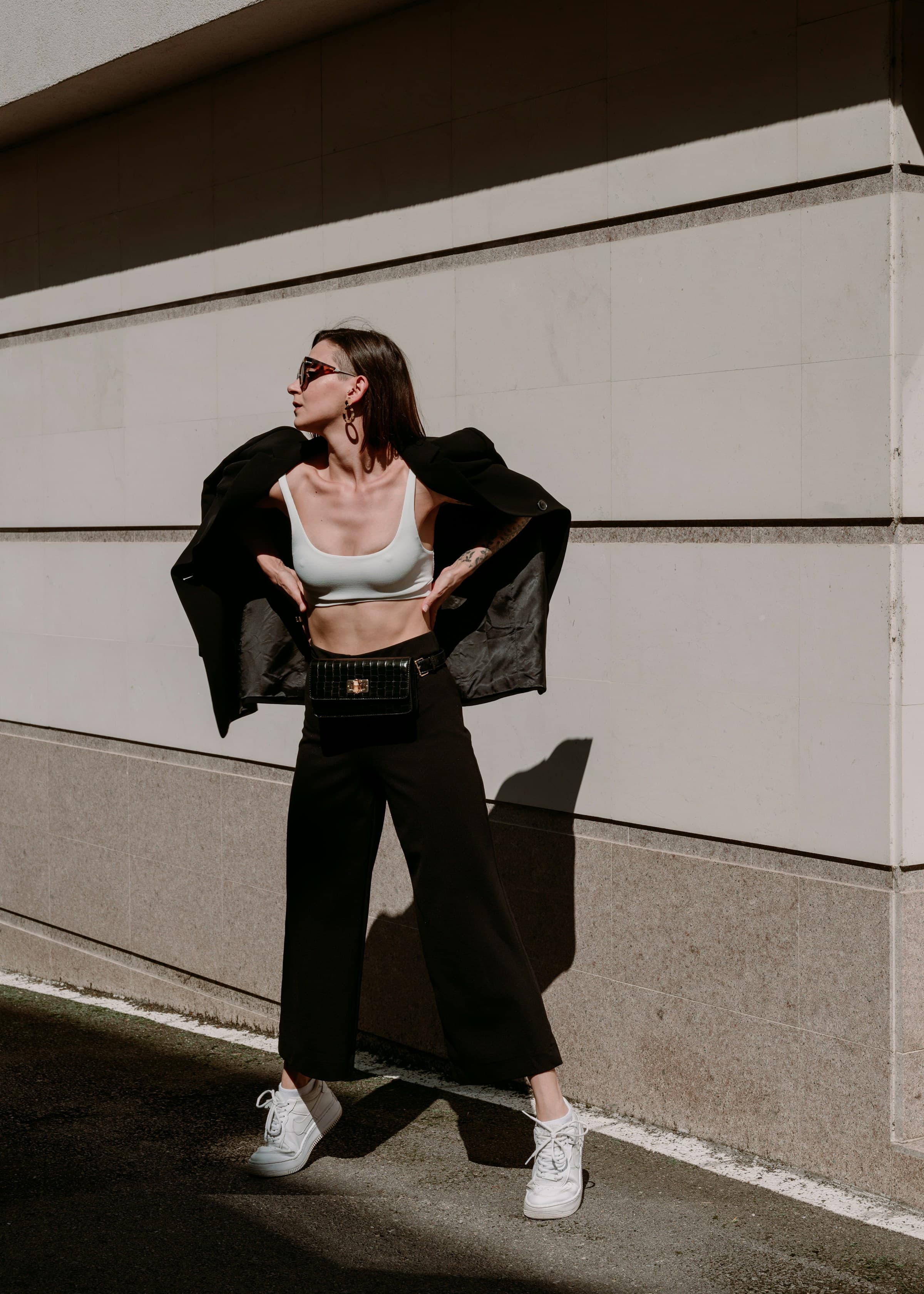 Full-length street-style frame of a model in a cropped top and wide-leg trousers